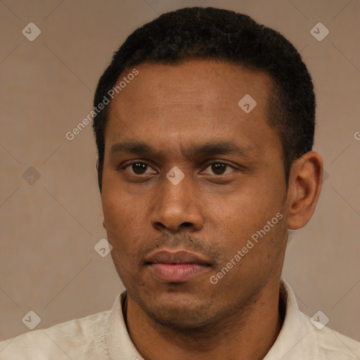 Neutral latino young-adult male with short  black hair and brown eyes