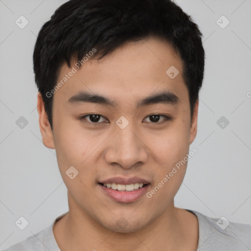 Joyful asian young-adult male with short  black hair and brown eyes