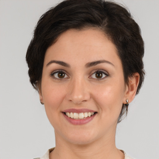 Joyful white young-adult female with medium  brown hair and brown eyes