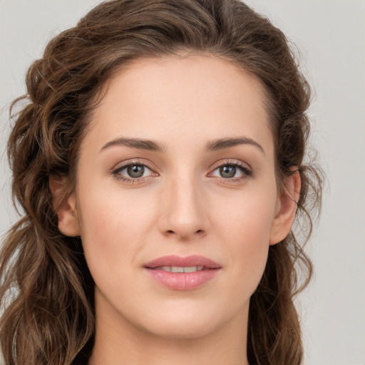 Joyful white young-adult female with long  brown hair and green eyes