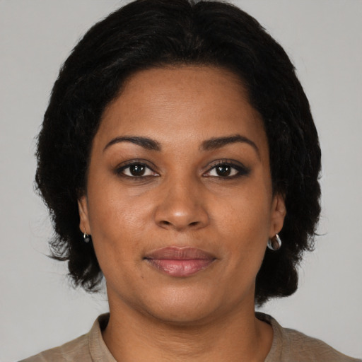 Joyful black young-adult female with medium  black hair and brown eyes