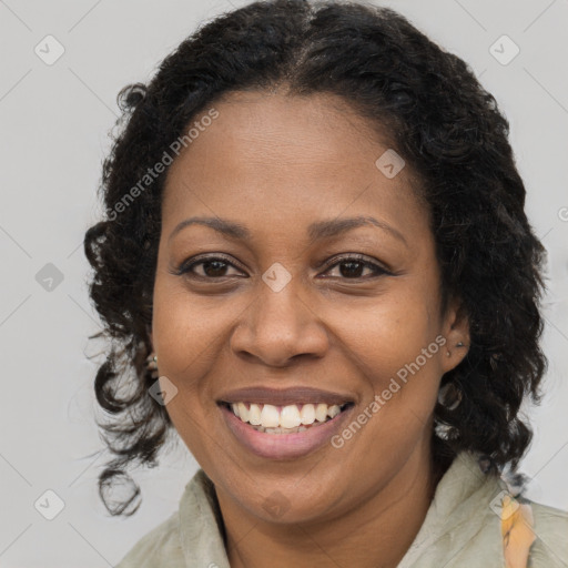 Joyful black adult female with long  brown hair and brown eyes