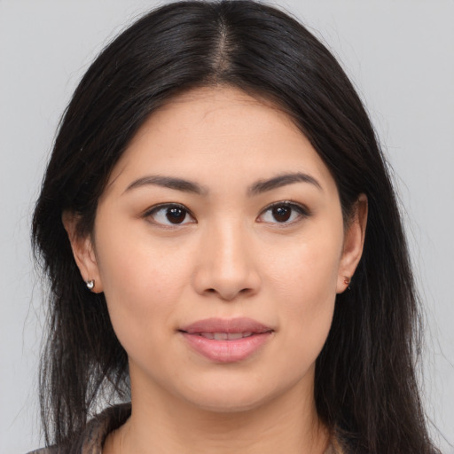 Joyful asian young-adult female with long  brown hair and brown eyes