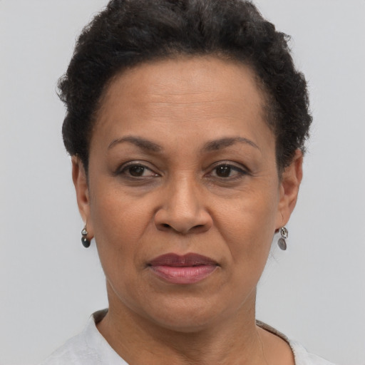 Joyful black adult female with short  black hair and brown eyes