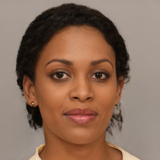 Joyful black young-adult female with medium  brown hair and brown eyes