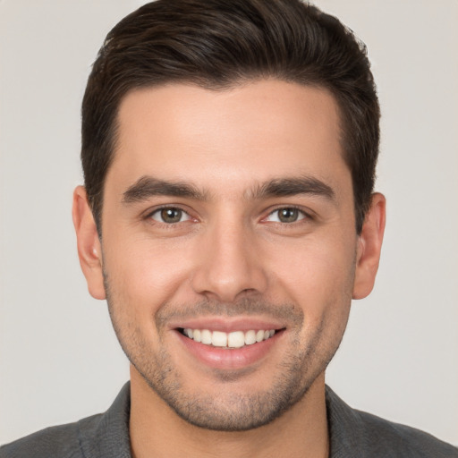 Joyful white young-adult male with short  brown hair and brown eyes