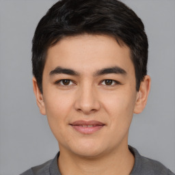 Joyful asian young-adult male with short  black hair and brown eyes