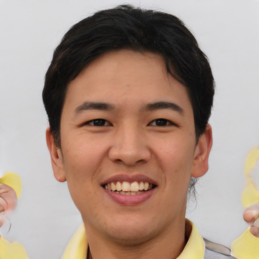Joyful asian young-adult male with short  brown hair and brown eyes