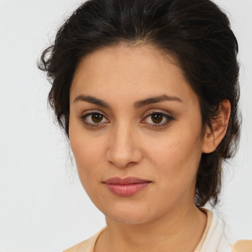 Joyful latino young-adult female with medium  brown hair and brown eyes