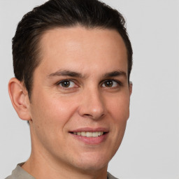 Joyful white young-adult male with short  brown hair and brown eyes