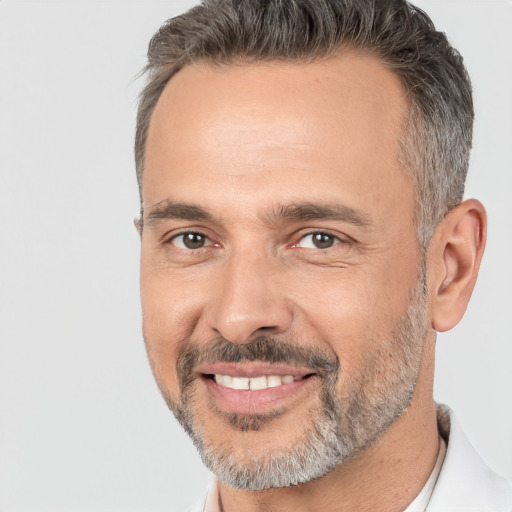 Joyful white adult male with short  brown hair and brown eyes