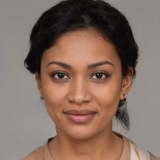 Joyful black young-adult female with medium  black hair and brown eyes