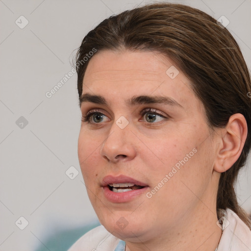 Joyful white adult female with medium  brown hair and brown eyes