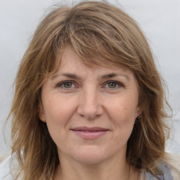 Joyful white adult female with medium  brown hair and grey eyes