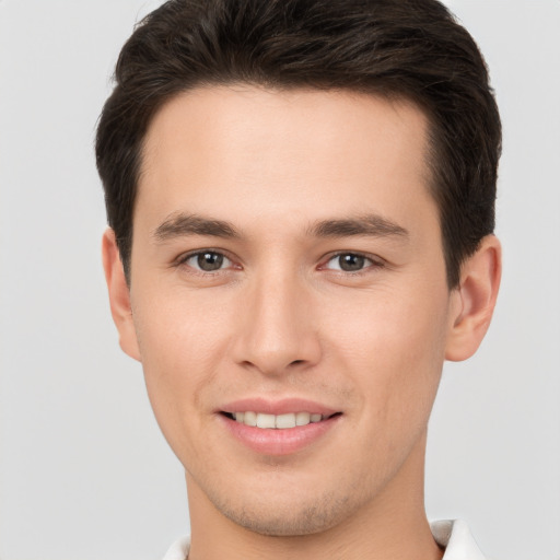 Joyful white young-adult male with short  brown hair and brown eyes