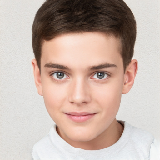 Joyful white child male with short  brown hair and brown eyes