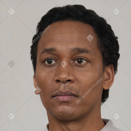 Neutral black adult male with short  black hair and brown eyes