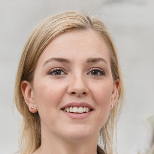 Joyful white young-adult female with medium  brown hair and grey eyes