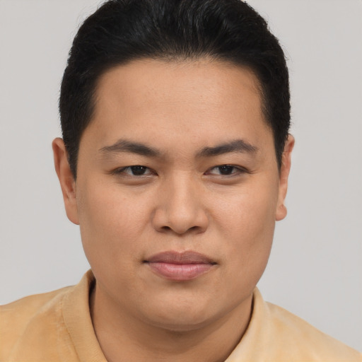 Joyful asian young-adult male with short  brown hair and brown eyes