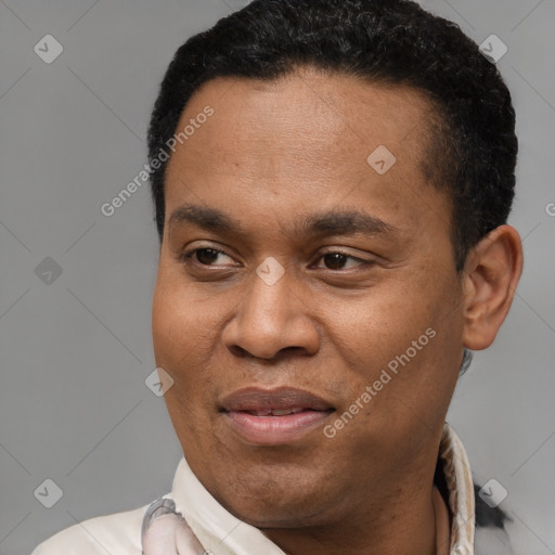 Joyful latino adult male with short  black hair and brown eyes