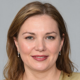 Joyful white young-adult female with medium  brown hair and blue eyes