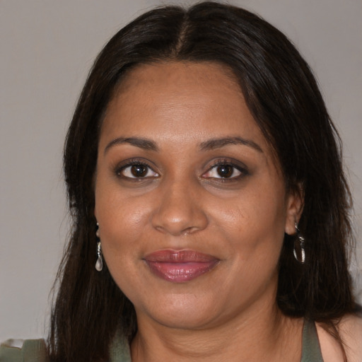 Joyful black adult female with medium  brown hair and brown eyes