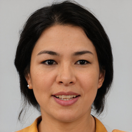 Joyful asian adult female with medium  brown hair and brown eyes