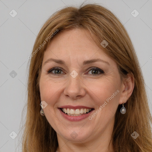 Joyful white adult female with long  brown hair and grey eyes