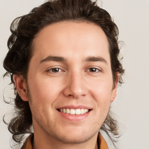 Joyful white young-adult male with medium  brown hair and brown eyes