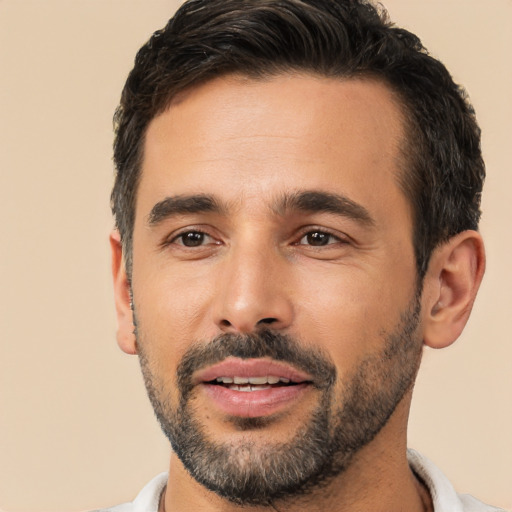 Joyful white young-adult male with short  black hair and brown eyes