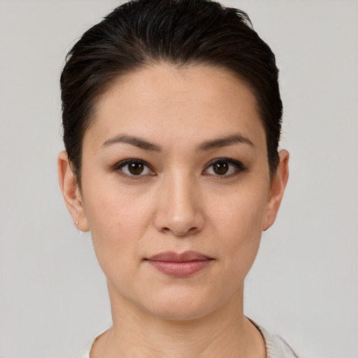 Joyful white young-adult female with short  brown hair and brown eyes
