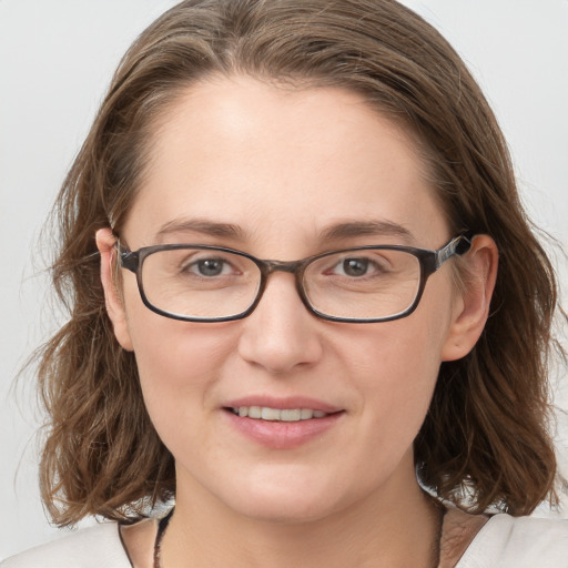 Joyful white young-adult female with medium  brown hair and blue eyes