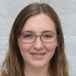 Joyful white young-adult female with long  brown hair and blue eyes