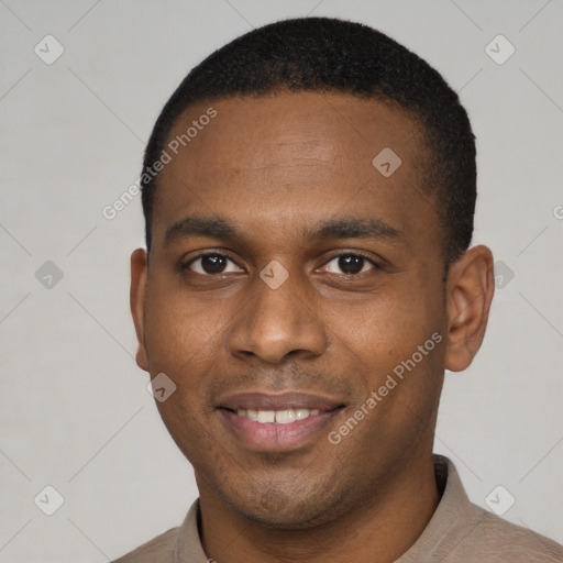 Joyful black young-adult male with short  brown hair and brown eyes