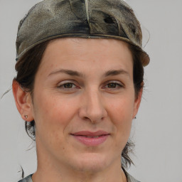 Joyful white adult female with short  brown hair and grey eyes