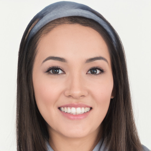 Joyful white young-adult female with long  black hair and brown eyes