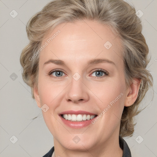 Joyful white young-adult female with medium  brown hair and blue eyes