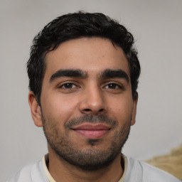 Joyful latino young-adult male with short  black hair and brown eyes