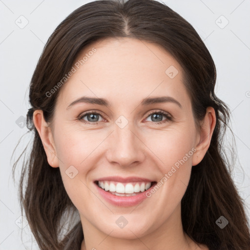 Joyful white young-adult female with long  brown hair and grey eyes