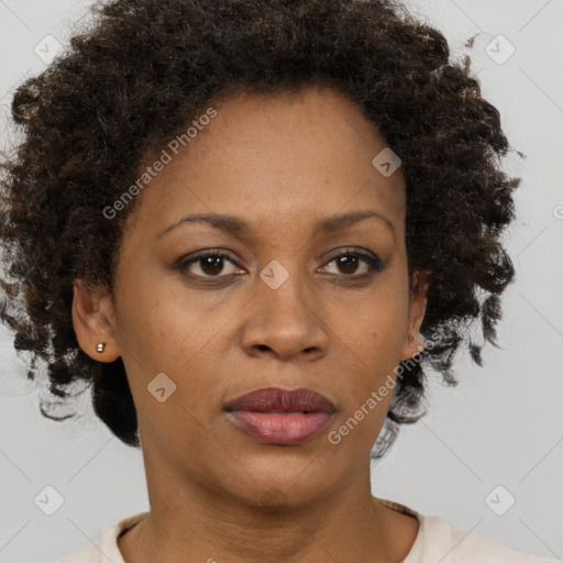 Joyful black adult female with short  brown hair and brown eyes