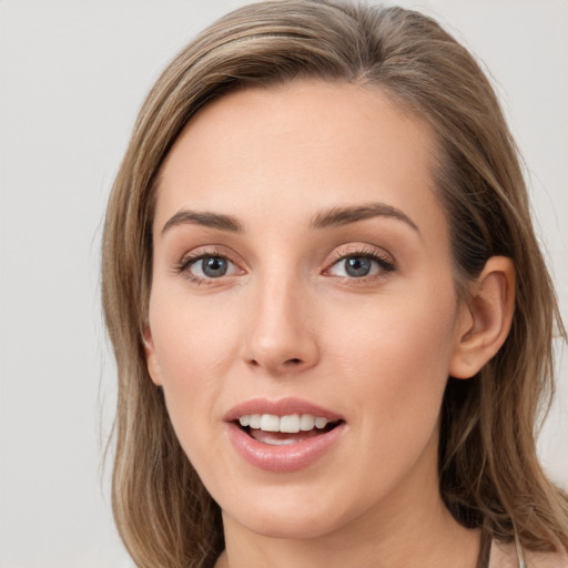 Joyful white young-adult female with long  brown hair and grey eyes