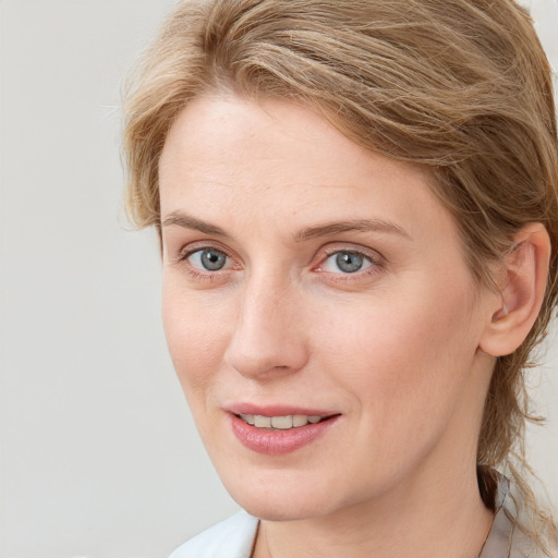 Joyful white young-adult female with medium  brown hair and blue eyes