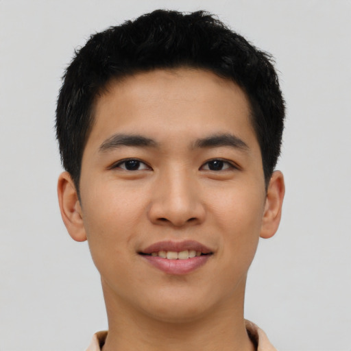 Joyful asian young-adult male with short  black hair and brown eyes