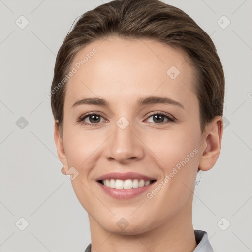 Joyful white young-adult female with short  brown hair and grey eyes