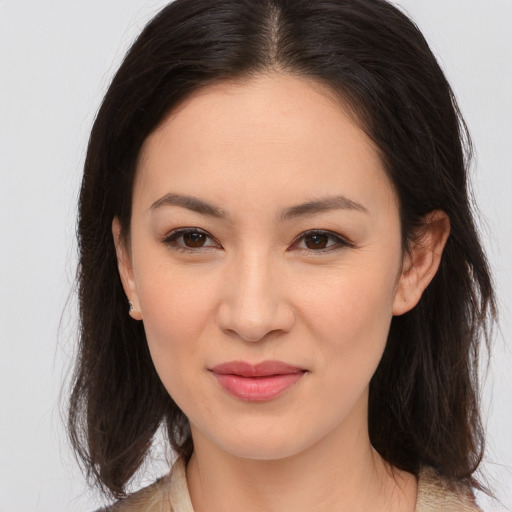 Joyful asian young-adult female with medium  brown hair and brown eyes