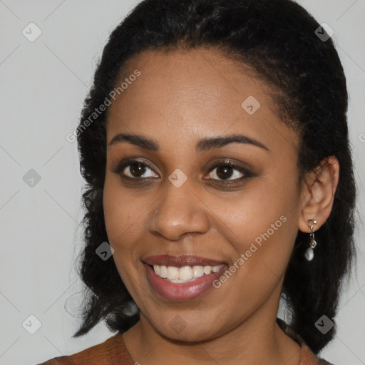 Joyful black young-adult female with medium  brown hair and brown eyes