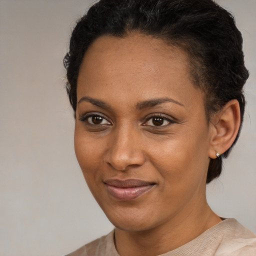 Joyful latino young-adult female with short  black hair and brown eyes