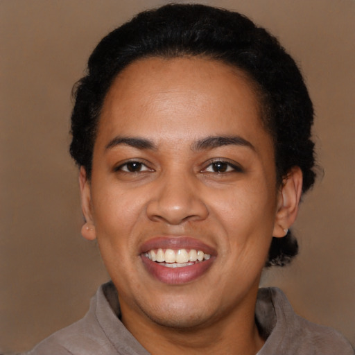 Joyful black adult female with short  black hair and brown eyes