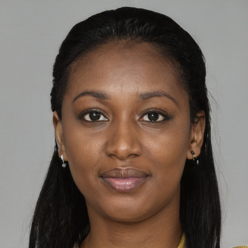 Joyful black young-adult female with long  black hair and brown eyes