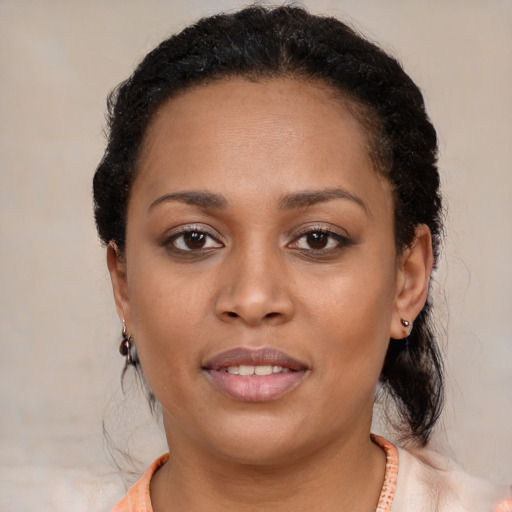 Joyful black young-adult female with short  black hair and brown eyes